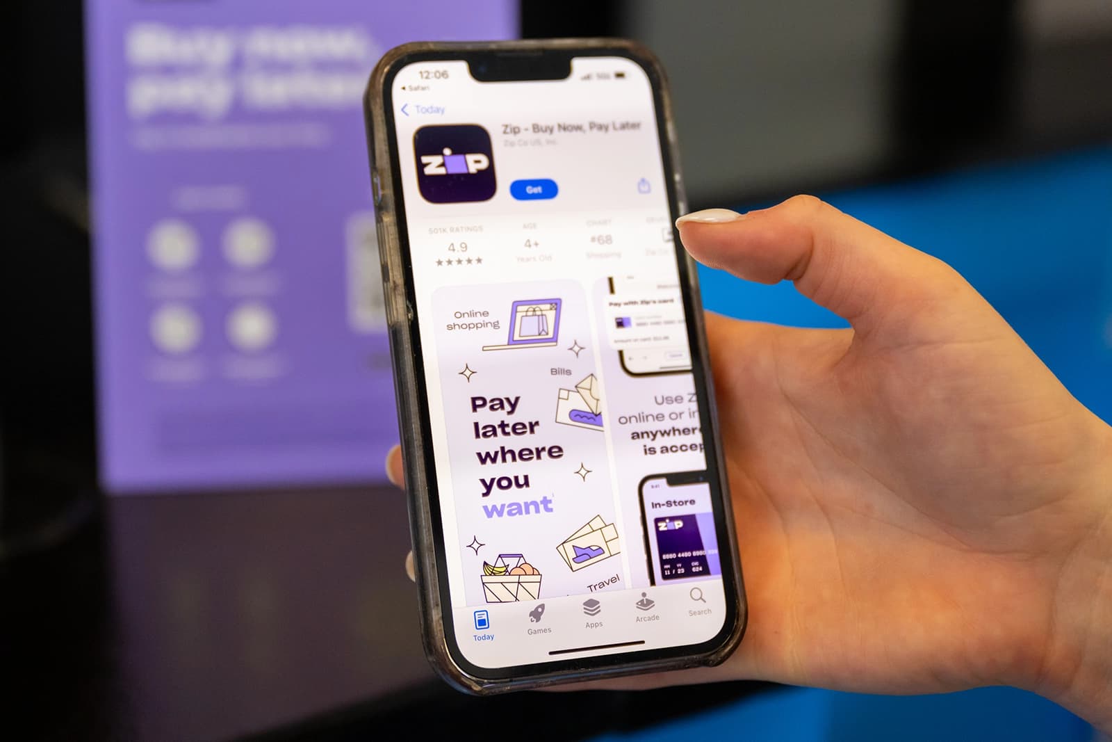 A hand holding a phone downloading the Zip app.