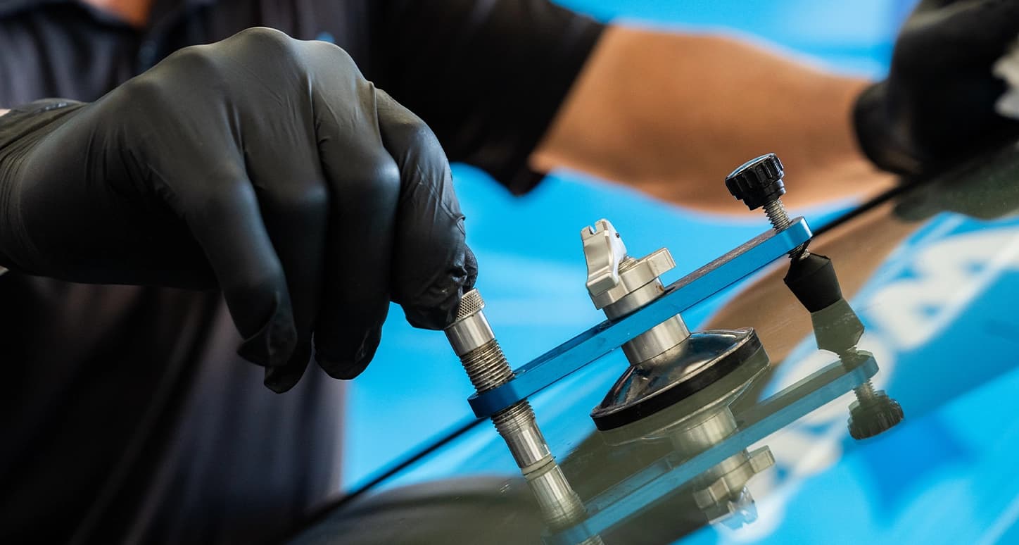 Technician repairing damaged windshield.