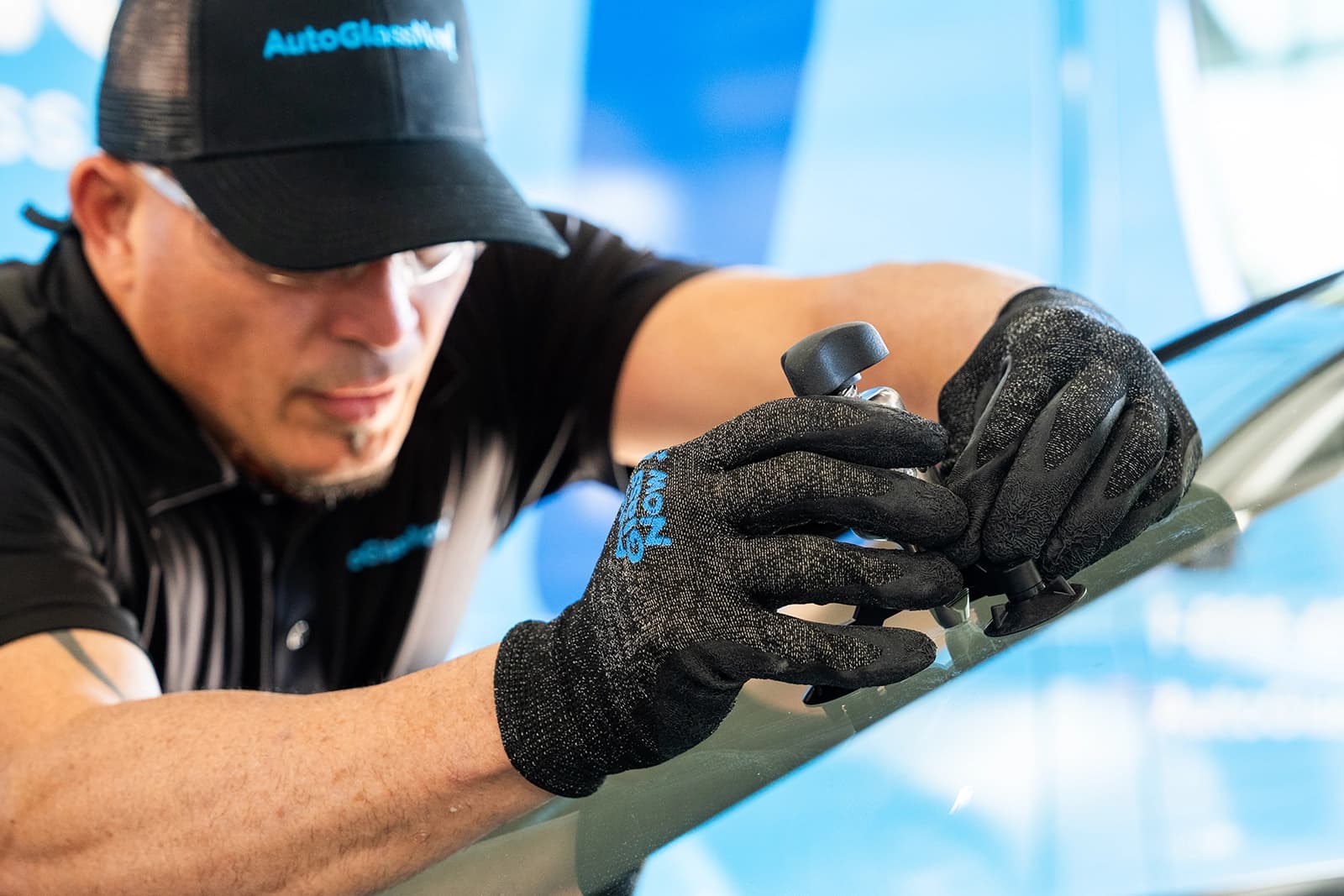 Technician repairing windshield.