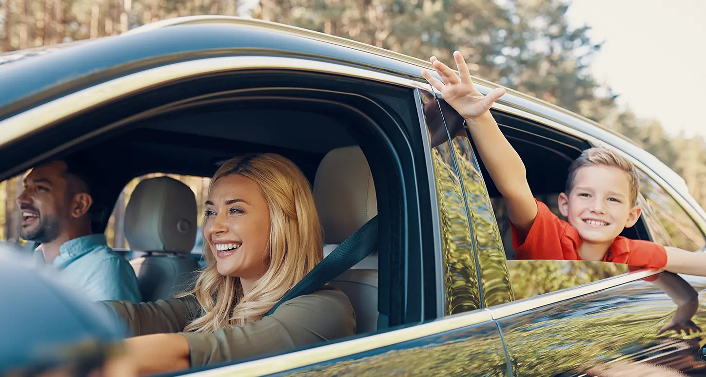 Smiling family in a car.