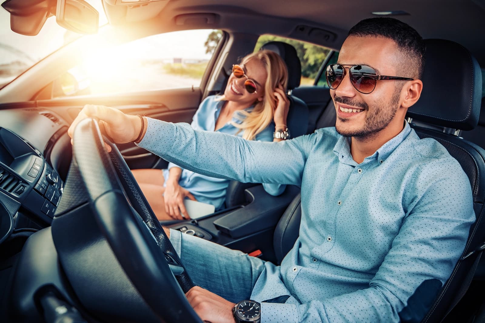 Happy couple driving in car