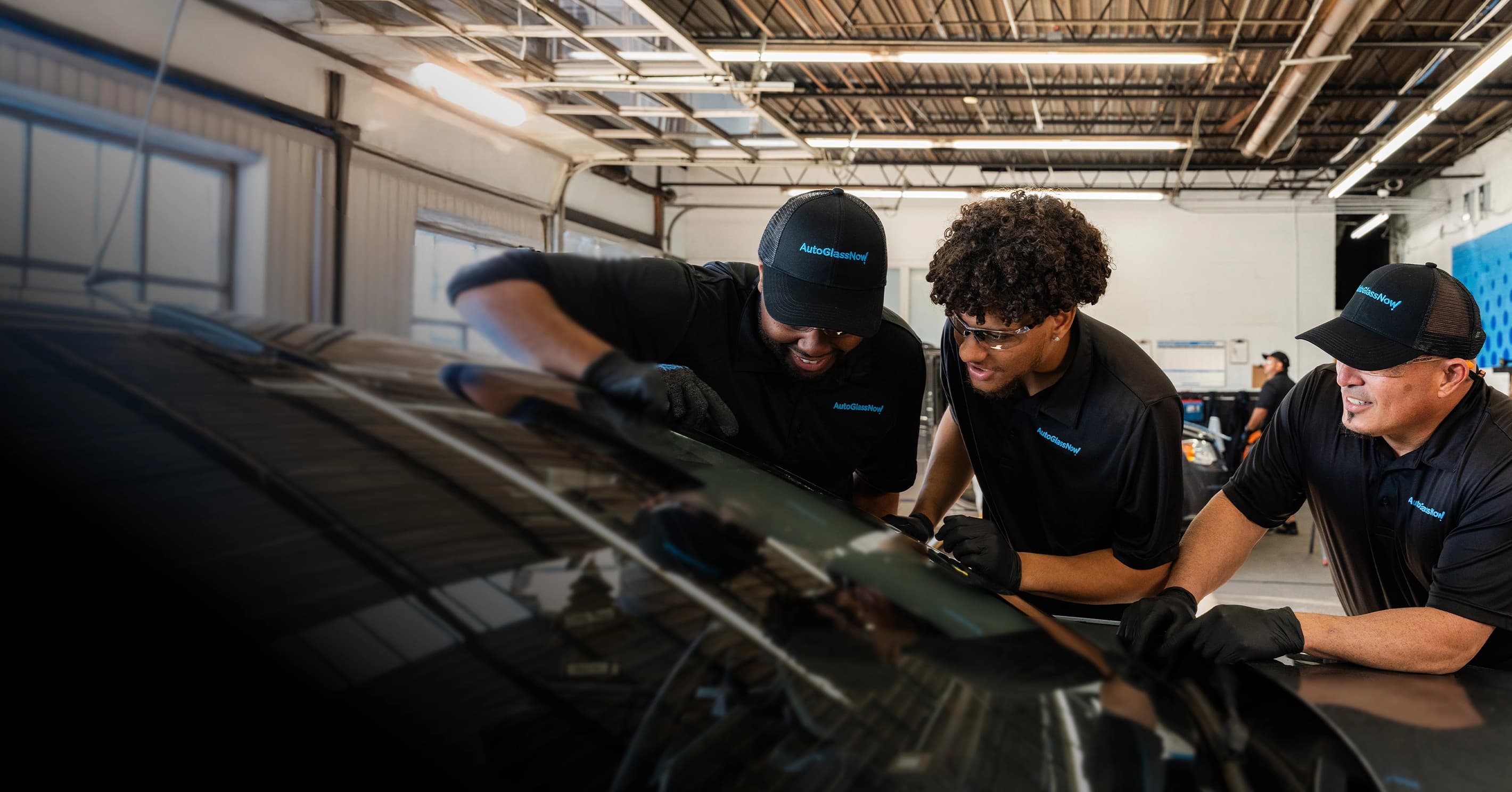 Technicians inspecting windshield.