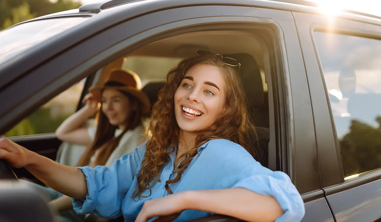 Two Smiling Women Driving