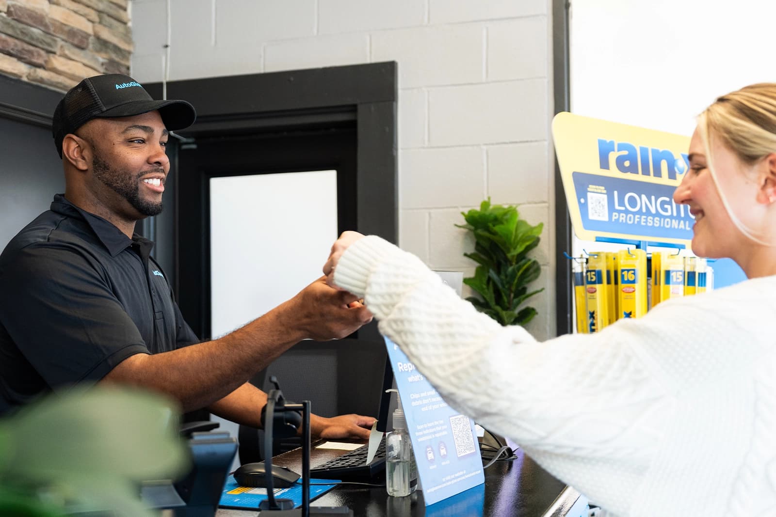 Technician handing keys to customer.
